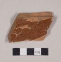 Undecorated lead glazed redware base sherd