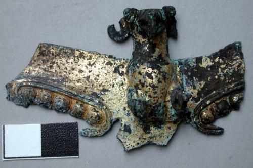 Metal figurine, partial, mounted on yellowed plastic, very corroded