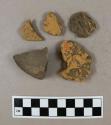 1 stone fragment and 1 clay wattle