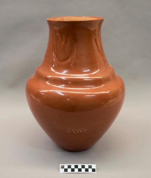 Carved red vase: bear paw motif