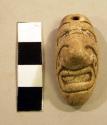 Shell amulet (human face)