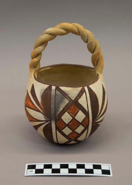 Polychrome-on-white globular Bowl with braided handle:  geometric motif
