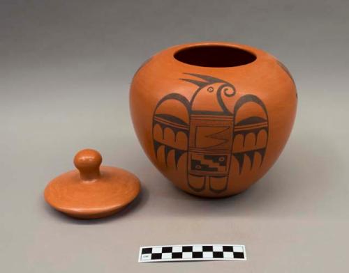 Black-on-red jar (A) with lid (B): stylized parrot motif