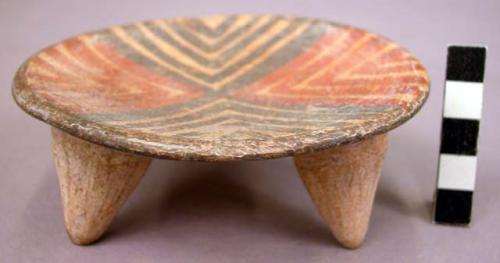 Pottery plate - tripod feet; polychrome on inside surface;