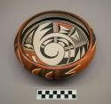 Polychrome-on-red bowl: geometric and spiraling parrot motifs