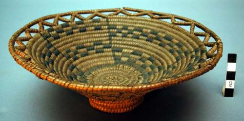 Coiled basket with small foot, open work around rim.