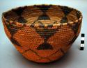 Deep utility basket bowl, coiled. Made of bear grass and devil's claw.