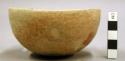 Hemispherical bowl; slightly incurved rim, body repaired; rounded base, fireclou