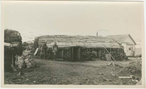 Arctic Voyage of Schooner Polar Bear - Men standing outside long building