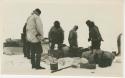 Arctic Voyage of Schooner Polar Bear - Crew loading or unloading supplies from sled