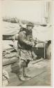 Arctic Voyage of Schooner Polar Bear - Man standing on deck holding camera