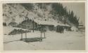 Arctic Voyage of Schooner Polar Bear - Log cabin covered in snow