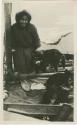 Arctic Voyage of Schooner Polar Bear - Woman on deck with three dogs