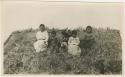 Arctic Voyage of Schooner Polar Bear - Local children sitting in grass