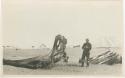 Arctic Voyage of Schooner Polar Bear - Man next to whale bones