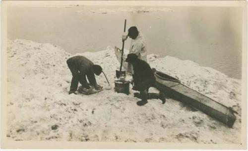 Arctic Voyage of Schooner Polar Bear - Crew next to canoe with shovel and bucket