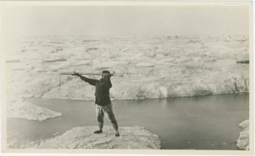 Arctic Voyage of Schooner Polar Bear - Man with spear standing on the ice