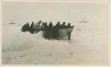 Arctic Voyage of Schooner Polar Bear - Crew pushing smaller boat over ice