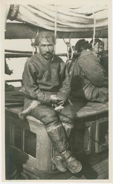 Arctic Voyage of Schooner Polar Bear - Man sitting on deck looking at camera