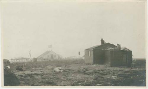 Arctic Voyage of Schooner Polar Bear - Small wooden building, dogs sleeping in yard