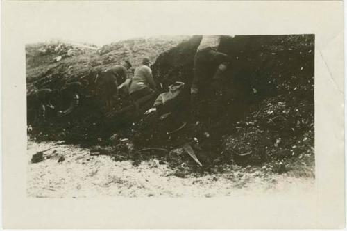 Arctic Voyage of Schooner Polar Bear - Crew digging in bank for ivory and bone artifacts, St. Lawrence Island