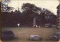 Men sitting at base of Mayan stela