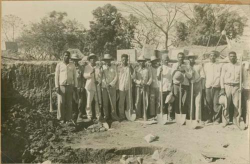 Group holding shovels, possibly excavation crew