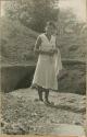 Girl standing near excavation site