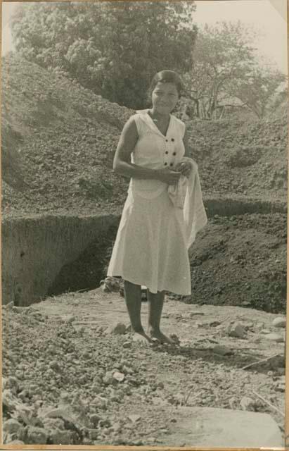 Girl standing near excavation site