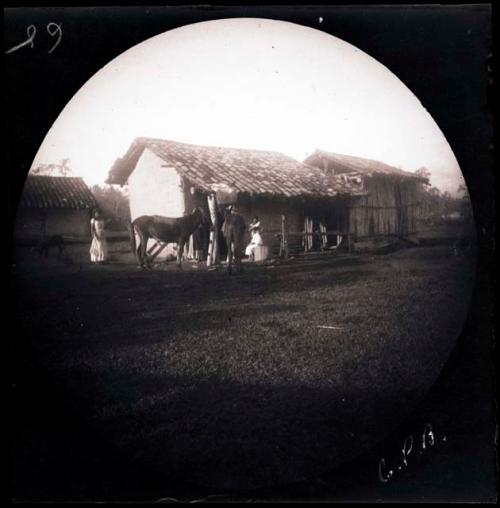 People and horses in front of building