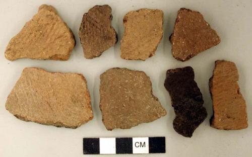 Ceramic, earthenware body sherds, cord-impressed and undecorated; one sherd is mended