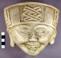 Cast of "laughing face" - geometric design in bas relief on forehead