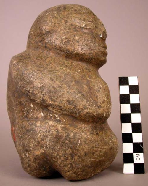 Stone human figure seated