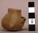 Miniature collared jar - white on buff ware, lug on side in form of face