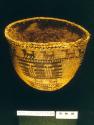 Twined bowl-shaped tule fiber basket: animal and humanoid motifs