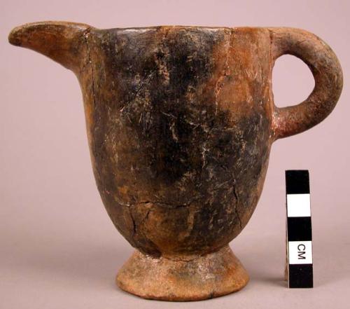 Small pitcher of orange buff ware