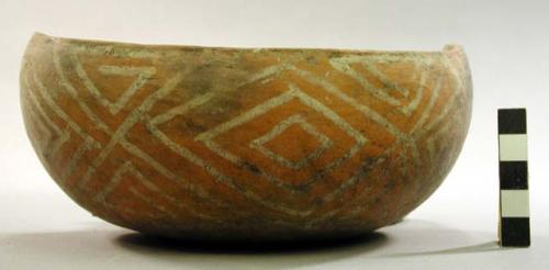 Ceramic bowl, partial, black on orange interior, white on orange exterior