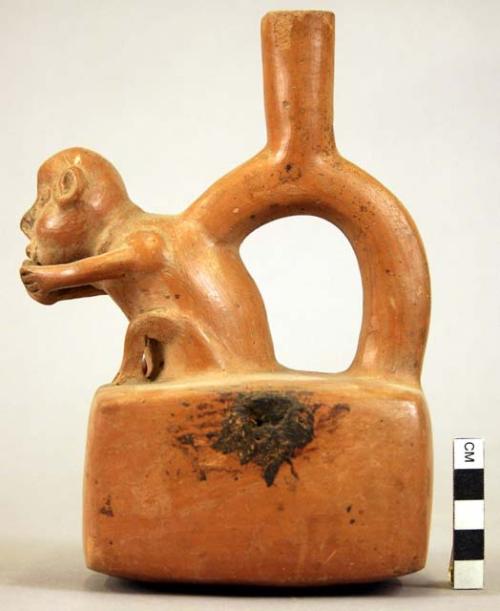 Pottery jar mouth in center of cross handle, monkey head, red