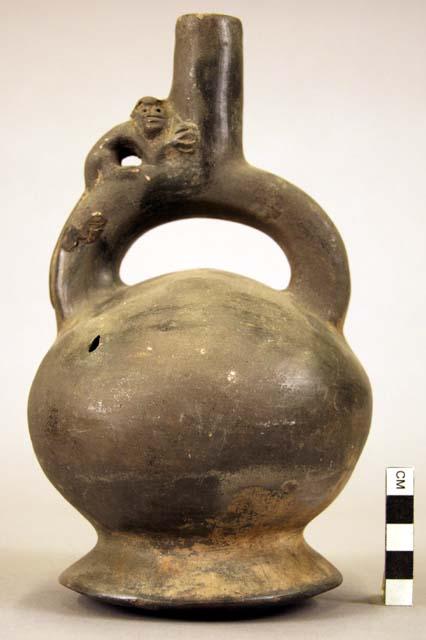 Pottery jar mouth in center of cross handle, monkey on side