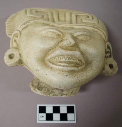 Cast of "laughing face"- geometric design in bas relief on forehead