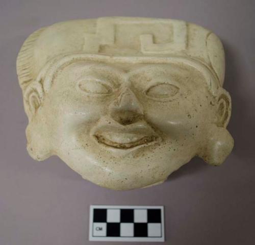 Cast of "laughing face"- geometric design in bas relief on forehead