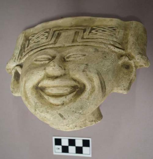 Cast of "laughing face"- geometric design in bas relief on forehead