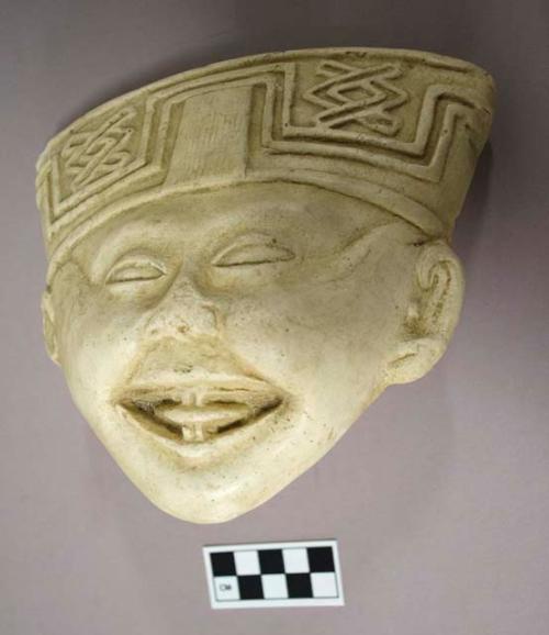 Cast of "laughing face"- geometric design in bas relief on forehead