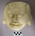 Cast of "laughing face"- geometric design in bas relief on forehead