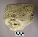 Cast of "laughing head" -scroll design on bas relief on side of forehead with de