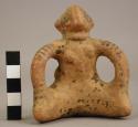 Red and Black Line solid figurine of a seated female with traces of child on bac