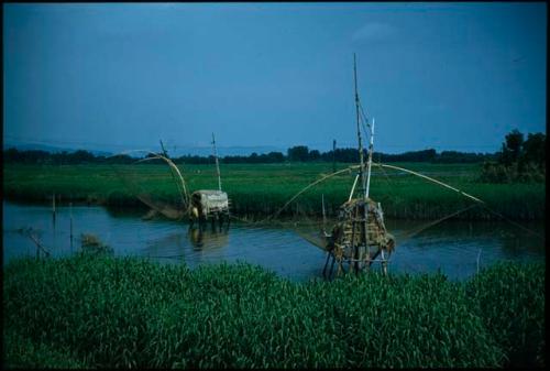 Canal with fishing nets on stilts