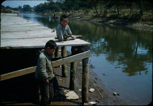 Two boys next to dock