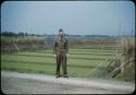 George Butler standing in front of rice seedbed