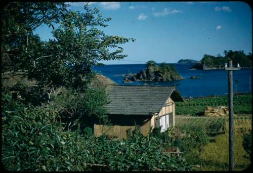 Building and garden, with shore in background